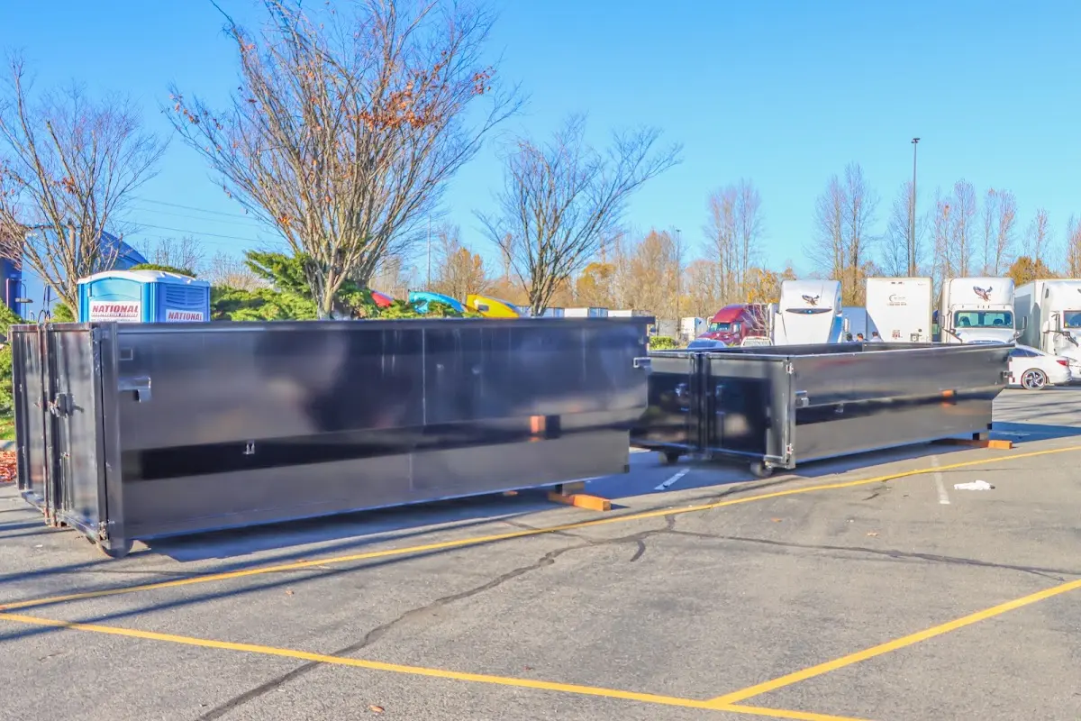 Professional dumpster rental service with roll-off container on residential driveway in Hot Springs Village